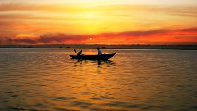 Boat in River Ganga at sunrise, Varanasi, India. (Ganges; sunrise; sky; sky color; atmosphere; dawn)