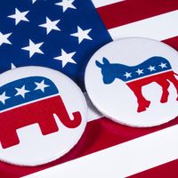 The Elephant symbol of the Republican Party and the Donkey symbol of the Democratic Party, with the American flag behind