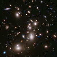 Galaxy clusters like Abell 2744 can act as a natural cosmic lens, magnifying light from more distant, background objects through gravity. NASA's James Webb Space Telescope may be able to detect light from the first stars in the universe if they are gravitationally lensed by such clusters. (astronomy, space exploration, galaxies)