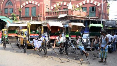 Hand pulled rickshaw drivers wait for passenger and try to stay cool in extreme heat on a summer afternoon May 20, 2015 in Calcutta, India. India heat wave, India heatwave, ricksha