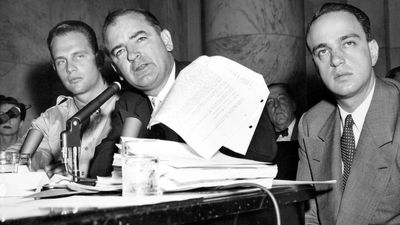 Senator Joseph McCarthy waves a transcript of a monitored call between Pvt. G. David Schine (left) & Secretary of the Army Stevens, Army-McCarthy hearings, June 7, 1954, Washington D.C. Investigation into Communist infiltration of the government. McCarthy