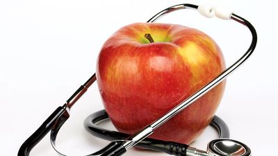 Apple and stethoscope on white background. Apples and Doctors. Apples and human health.