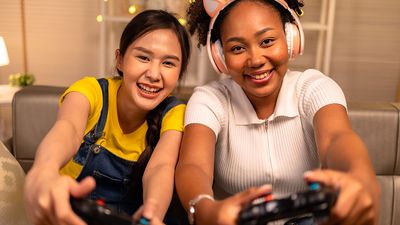 Two teenage girls having fun playing a video game together. Friends teenagers gaming